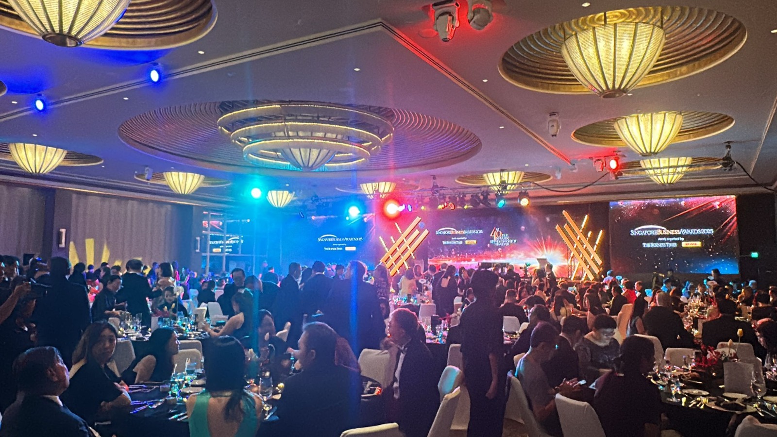 A*STAR Forum & Scholarship Award style gala — packed ballroom, LED content walls, stage lighting and black-tie audience