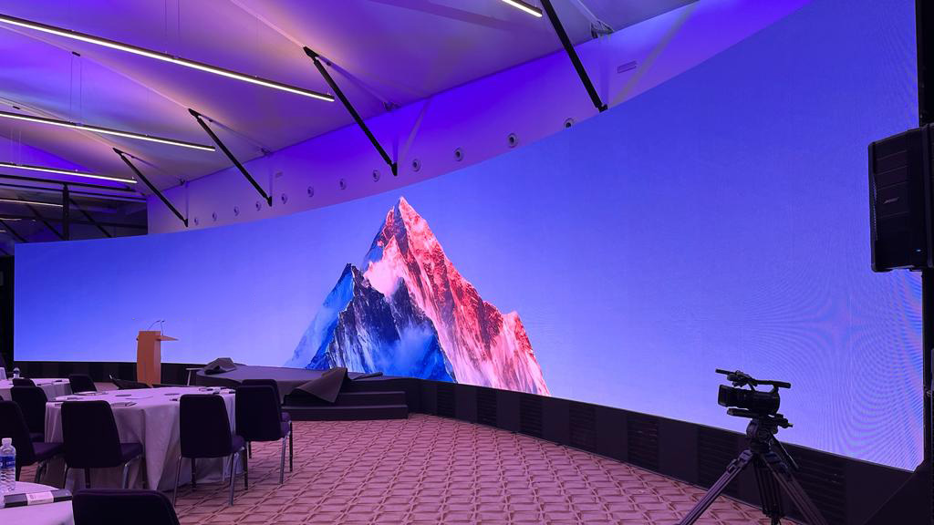 Curved LED video wall permanent installation displaying vibrant content in Singapore venue